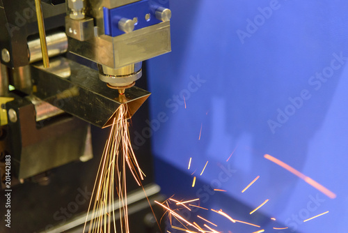 The CNC fiber laser cutting machine cut the square stainless pipe or tube with the sparking light.The modern sheet metal manufacturing process.