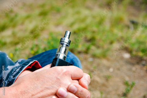 Electronic cigarette in middle-aged men in their hands 