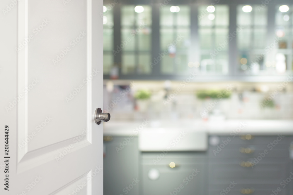 White door opened to the kitchen, blurred background White door opened to the kitchen, blurred background