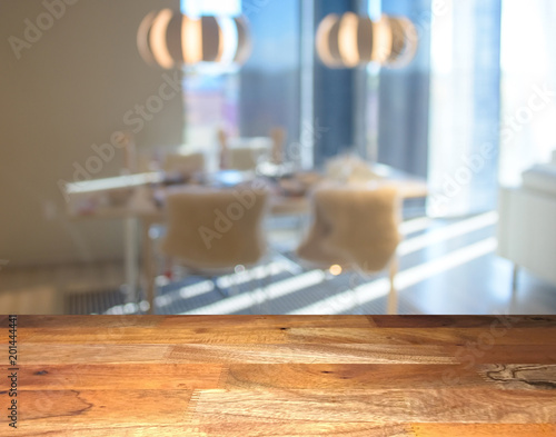 Empty wooden display table top front with blurred kitchen on background