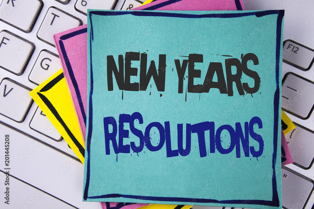 Fototapeta premium Handwriting text writing New Year'S Resolutions. Concept meaning Goals Objectives Targets Decisions for next 365 days written on Sticky note paper placed on Laptop Keyboard Sticky Note papers.