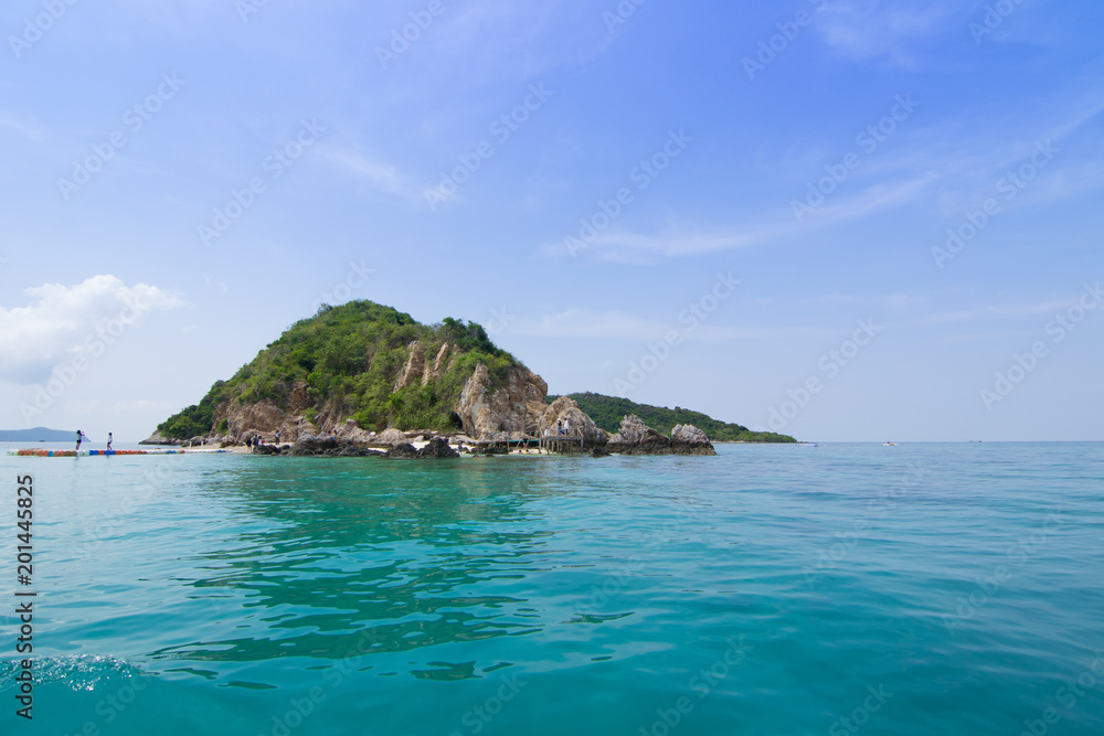 Fototapeta premium Island in sea which has boat tourists on the beach