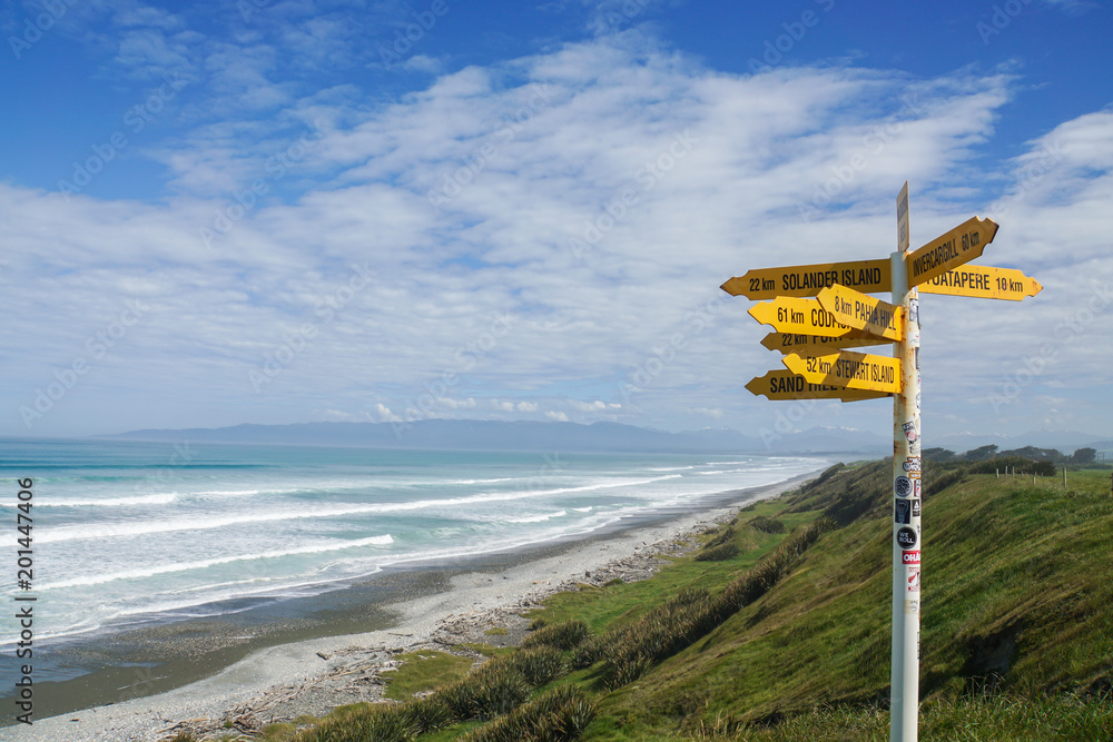 direction and  distance post in McCrackens Rest in New Zealand taken on 4 November 2017 - obrazy, fototapety, plakaty 