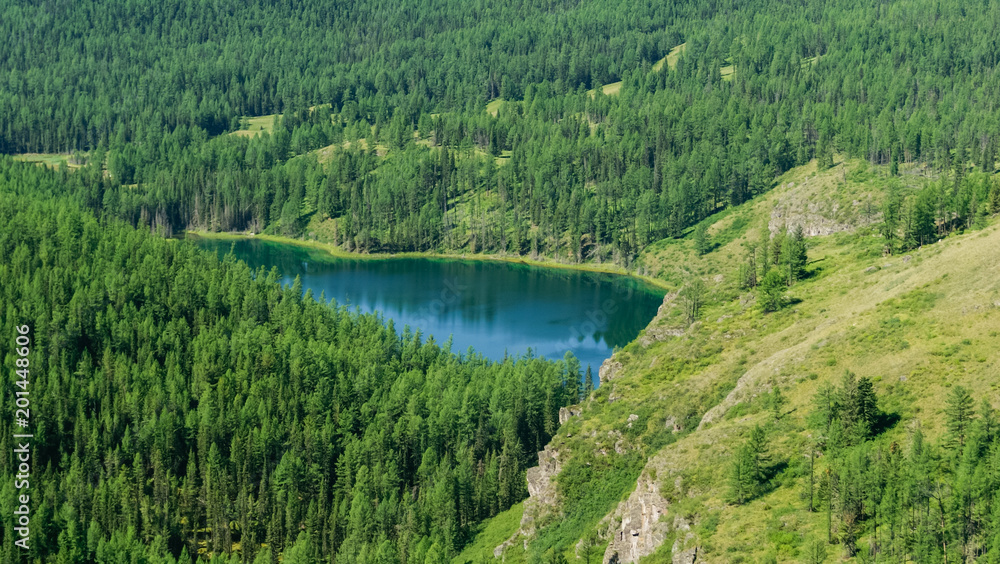 Blue water mountain lake in the middle of forest