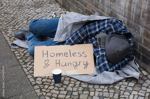 Male Beggar Lying On Street