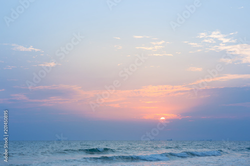 Sunset at the beach and with fishing boats and cargo ships.