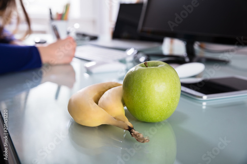 Fototapeta Naklejka Na Ścianę i Meble -  Close-up Of Bananas And Green Apple