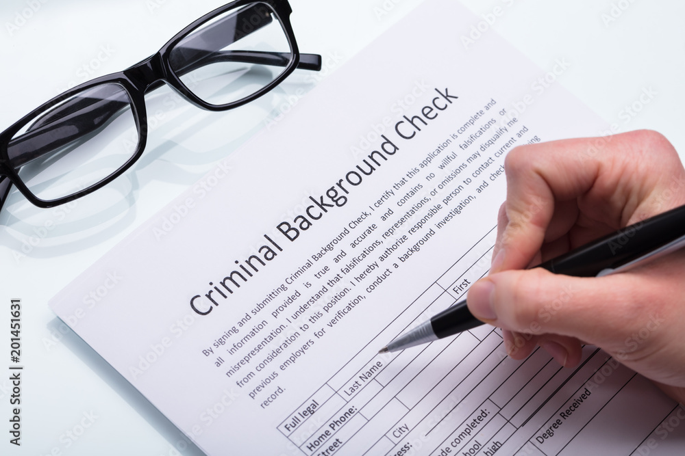 Person Filling Criminal Background Check Form
