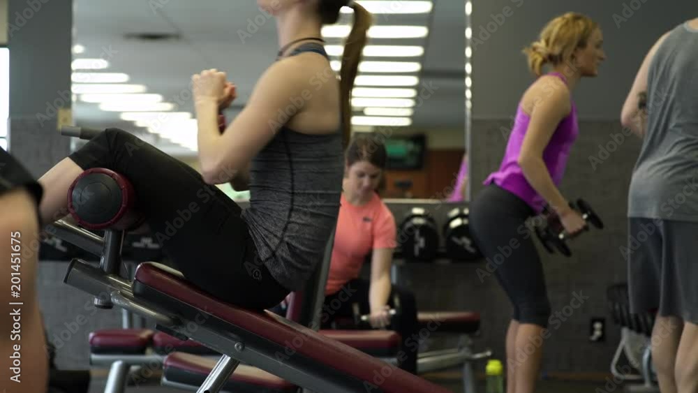 Young woman doing push-ups in a gym Young woman doing push-ups in a gym