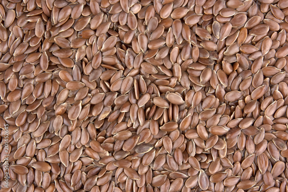 Flax seeds as natural background. Also known as Linseed, Flaxseed and Common Flax. Pile of grains, isolated white background.