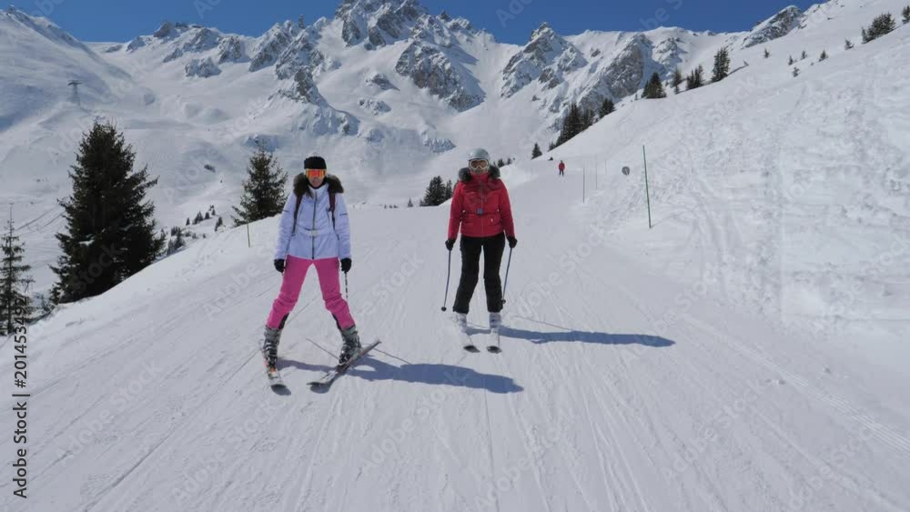 Portrait Two Woman Skiers Skiing Down The Ideal Slope Of The Mountain In Winter Portrait Two Woman Skiers Skiing Down The Ideal Slope Of The Mountain In Winter