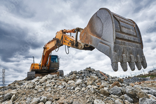 excavator loader machine at demolition construction site photo