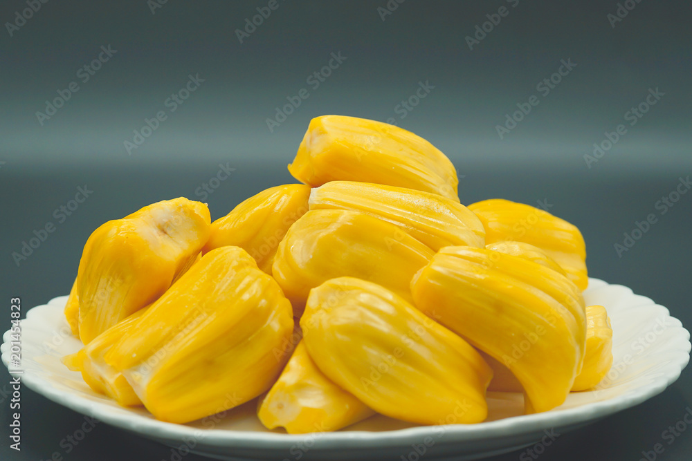 Fresh jackfruit slices on a white plate. sweet yellow jackfruit ripe. vegetarian, vegan, raw food. Exotic tropical fruit - isolated Fresh jackfruit slices on a white plate. sweet yellow jackfruit ripe. vegetarian, vegan, raw food. Exotic tropical fruit - isolated