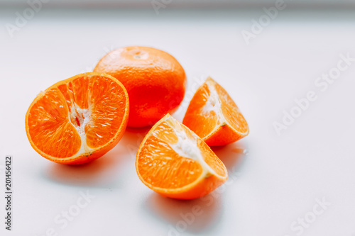 cut mandarins on white table