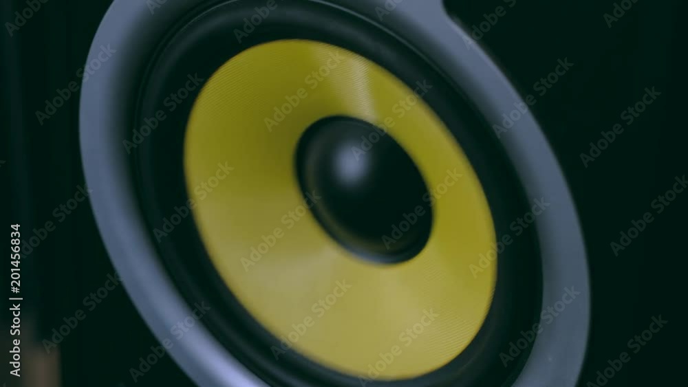 Close-up modern speakers play music at high volume. Low frequency loudspeaker with vibrating diaphragm. Close-up modern speakers play music at high volume. Low frequency loudspeaker with vibrating diaphragm.