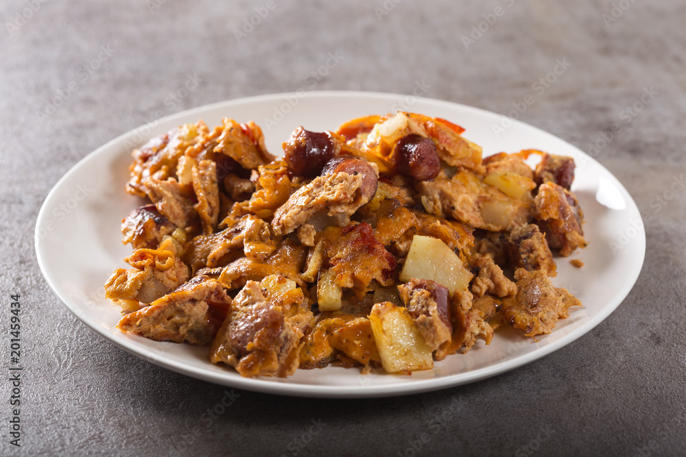 Omelette made from eggs, potatoes, sausages and tomato sauce Omelette made from eggs, potatoes, sausages and tomato sauce