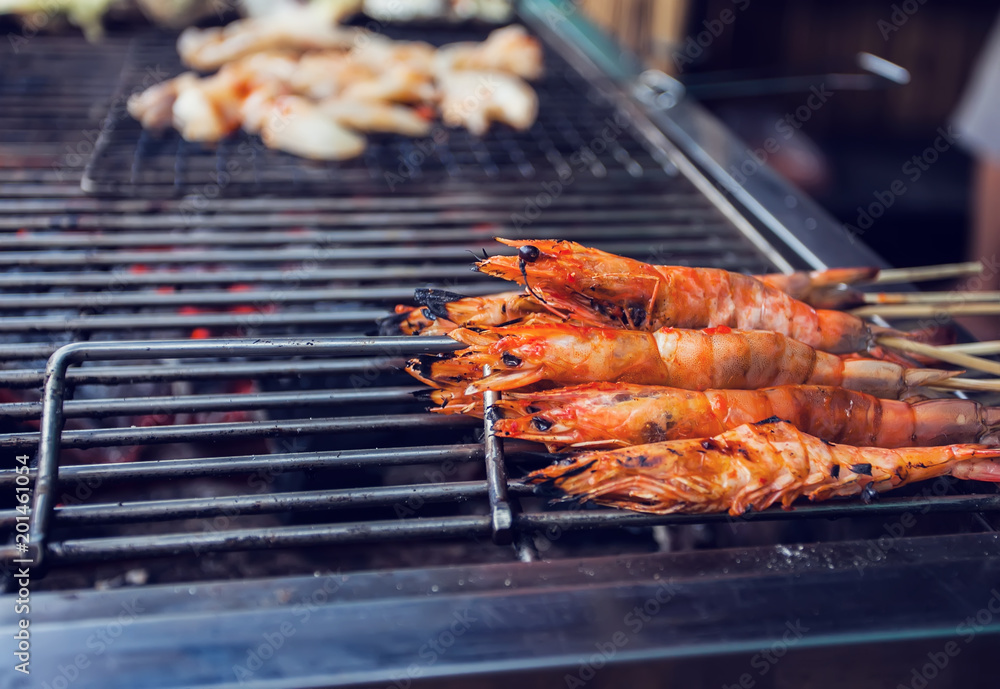 Grilled fresh shrimps on the flaming grill
