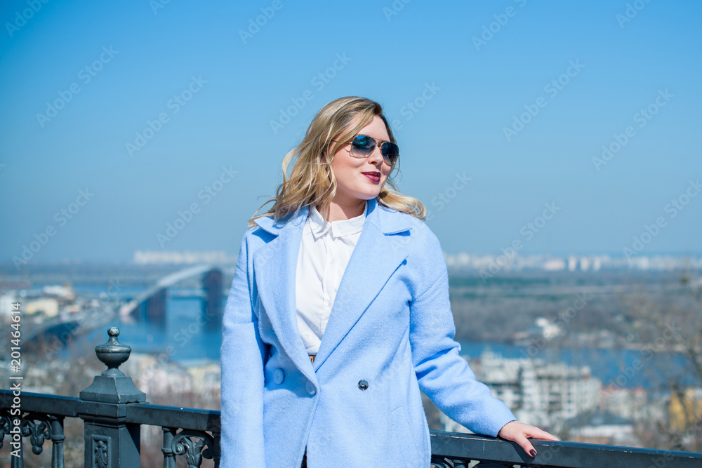 A woman of plus size, American or European appearance walks at city streets enjoying life. A young lady with excess weight, have a stylish dress. Natural beauty A woman of plus size, American or European appearance walks at city streets enjoying life. A young lady with excess weight, have a stylish dress. Natural beauty
