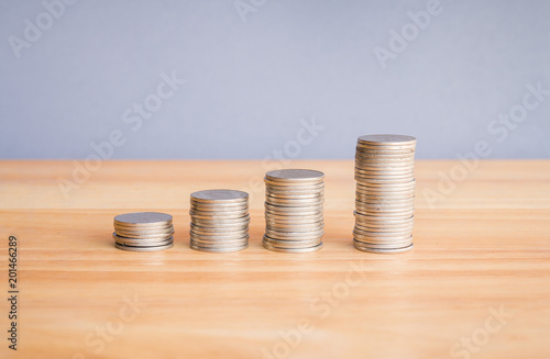 Stack of coin on wood desk with copy space