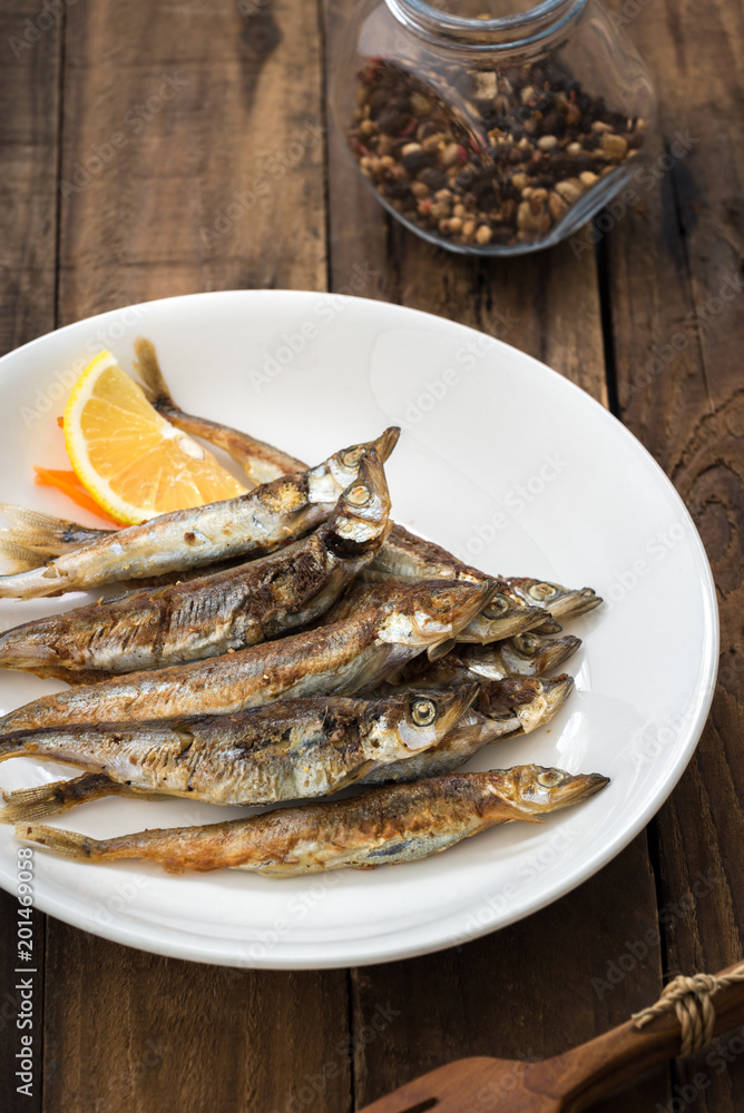 Grilled fish capelin or shishamo on white plate
Grilled fish capelin or shishamo on white plate