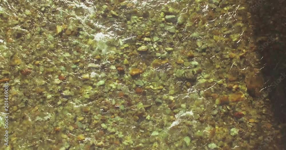 Aerial UHD 4K view. Mid-air flight over fresh and clean mountain river with transparent water and stone river bed at sunny summer morning. Top view and horizontal movement Aerial UHD 4K view. Mid-air flight over fresh and clean mountain river with transparent water and stone river bed at sunny summer morning. Top view and horizontal movement