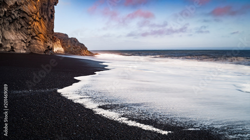 A long exposure seascape shot on a black sand beach in iceland photo