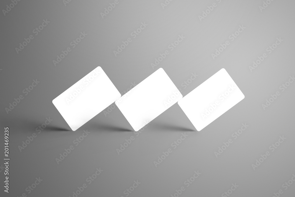 Universal white mockup of three bank gift cards isolated on a gray background. Universal white mockup of three bank gift cards isolated on a gray background.