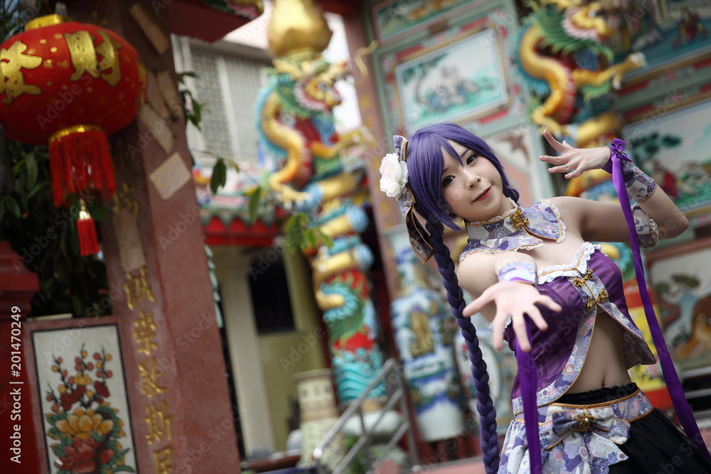 Portrait of asian young woman with purple Chinese dress cosplay with temple Portrait of asian young woman with purple Chinese dress cosplay with temple