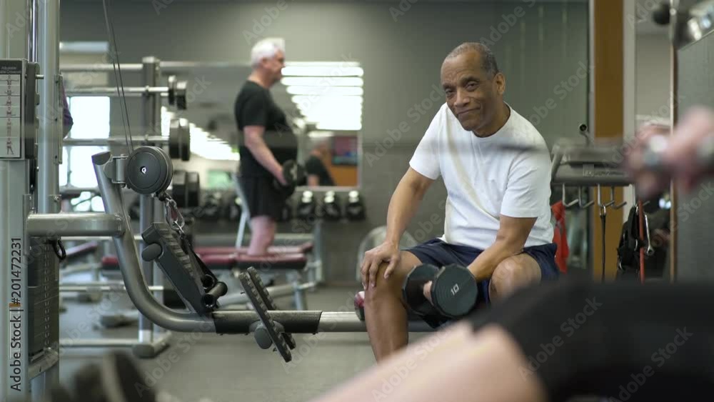 Mature man weightlifting in a gym Mature man weightlifting in a gym