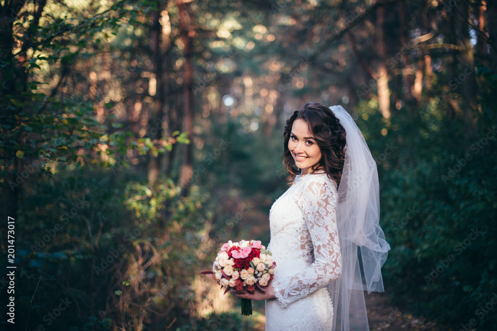 Beautiful bride outdoors in a forest.