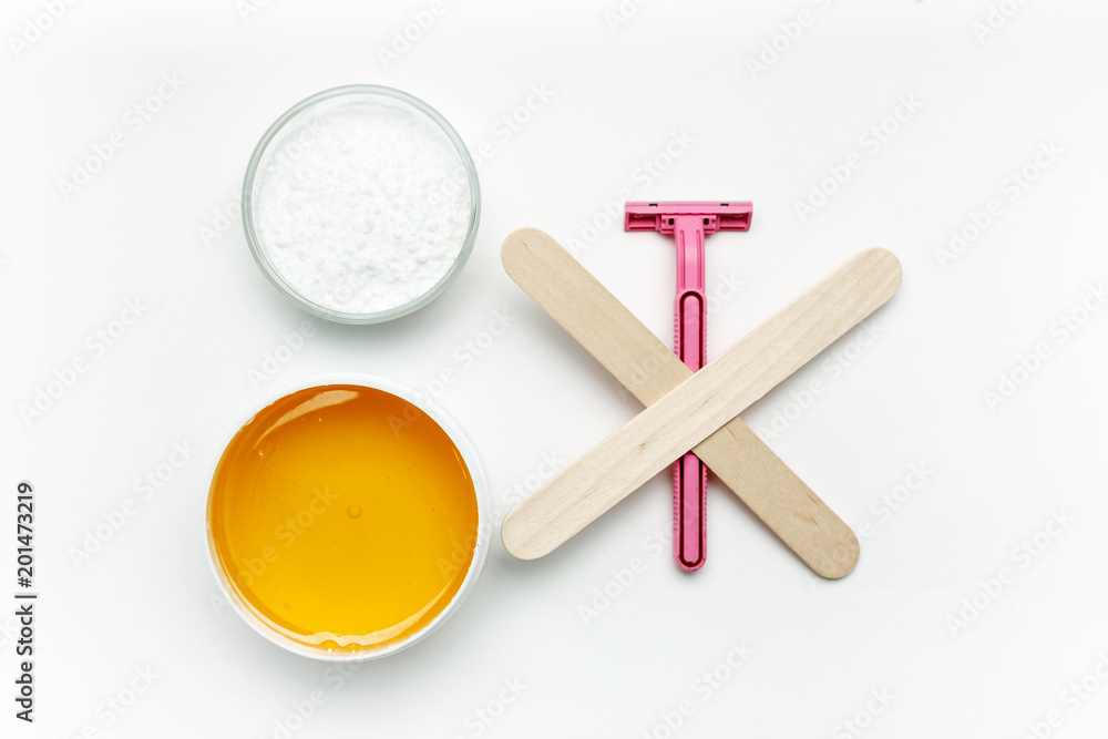 Tools for depilation on a white background, top view, flat lay