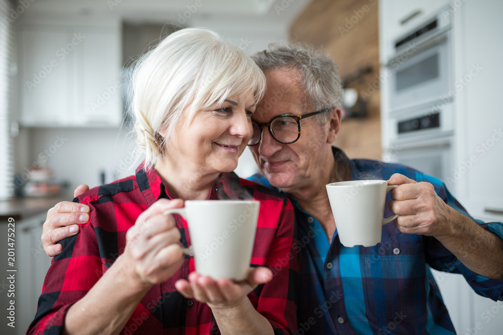 Happy senior couple having morning coffee together Happy senior couple having morning coffee together