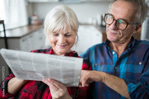 Senior couple reading newspaper together