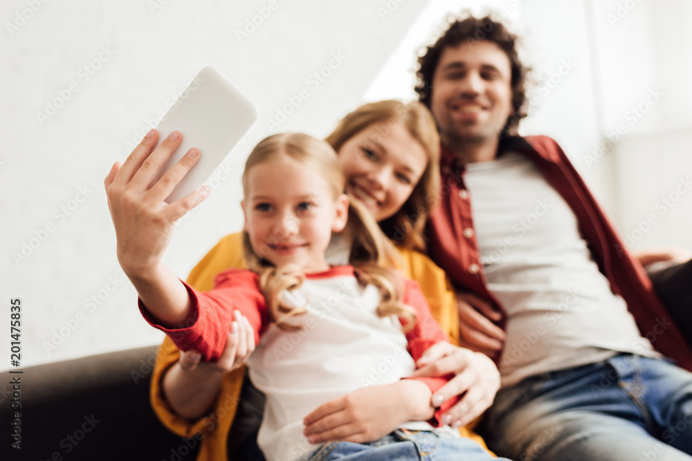 happy young family with one child taking selfie with smartphone happy young family with one child taking selfie with smartphone