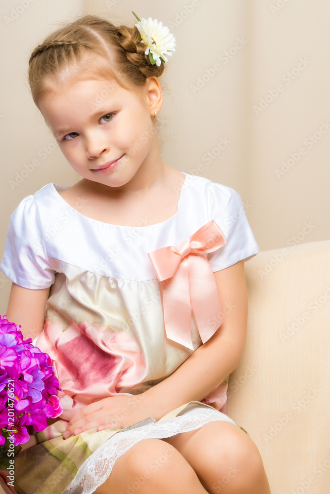 Little girl is sitting on the couch Little girl is sitting on the couch