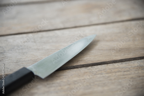Knife on wood table.