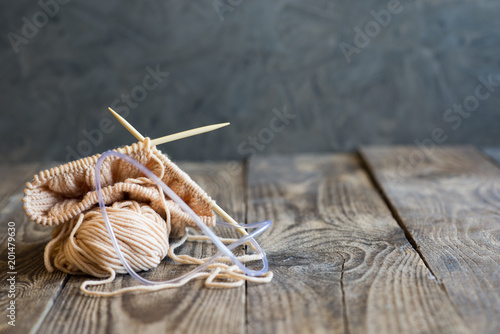 tangles with a knitting thread on a wooden table