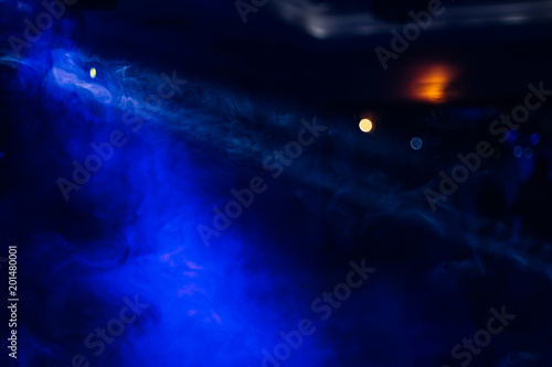 dark dance floor with decorative smoke and blue light in the club hall