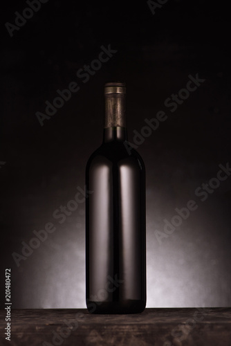 single bottle of luxury red wine on black