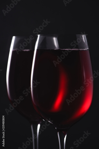 close-up shot of glasses full of luxury red wine on black