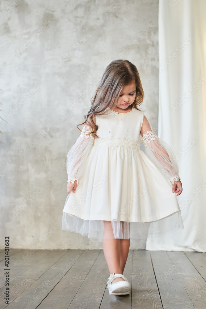 Children's fashion. Little stylish girl in white dress. Children's fashion. Little stylish girl in white dress.