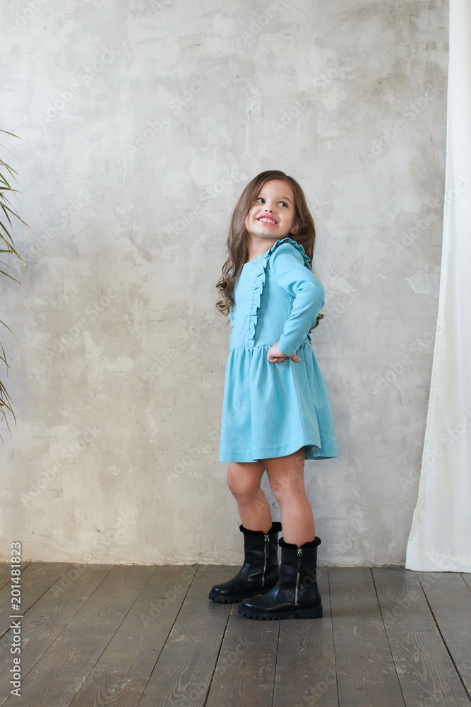 Children's lookbook. Stylish girl in a blue dress Children's lookbook. Stylish girl in a blue dress