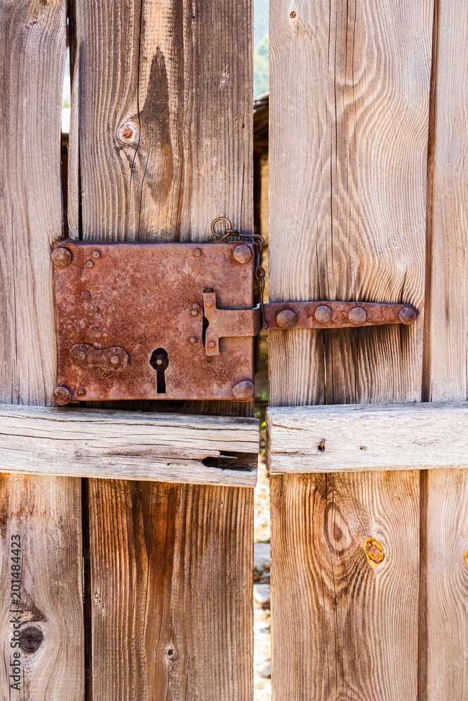 Close-up of a plank door with old rusted lock Close-up of a plank door with old rusted lock