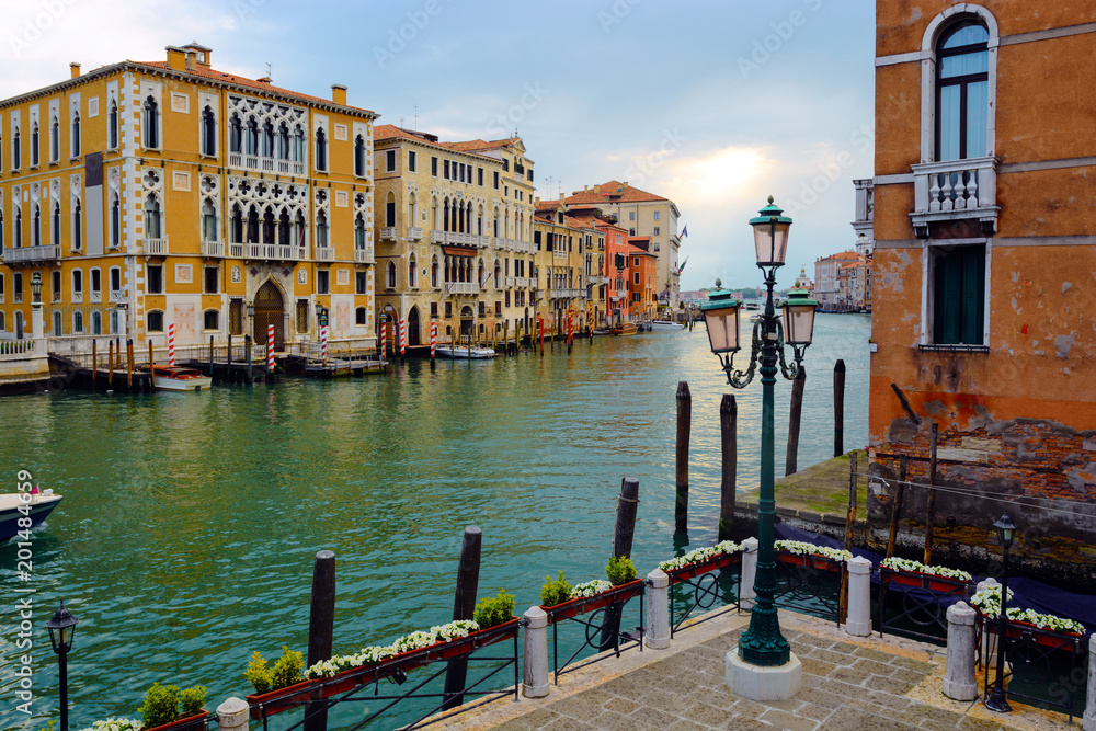 Pier with flowers and a street lamp in Grand Canal, Venice