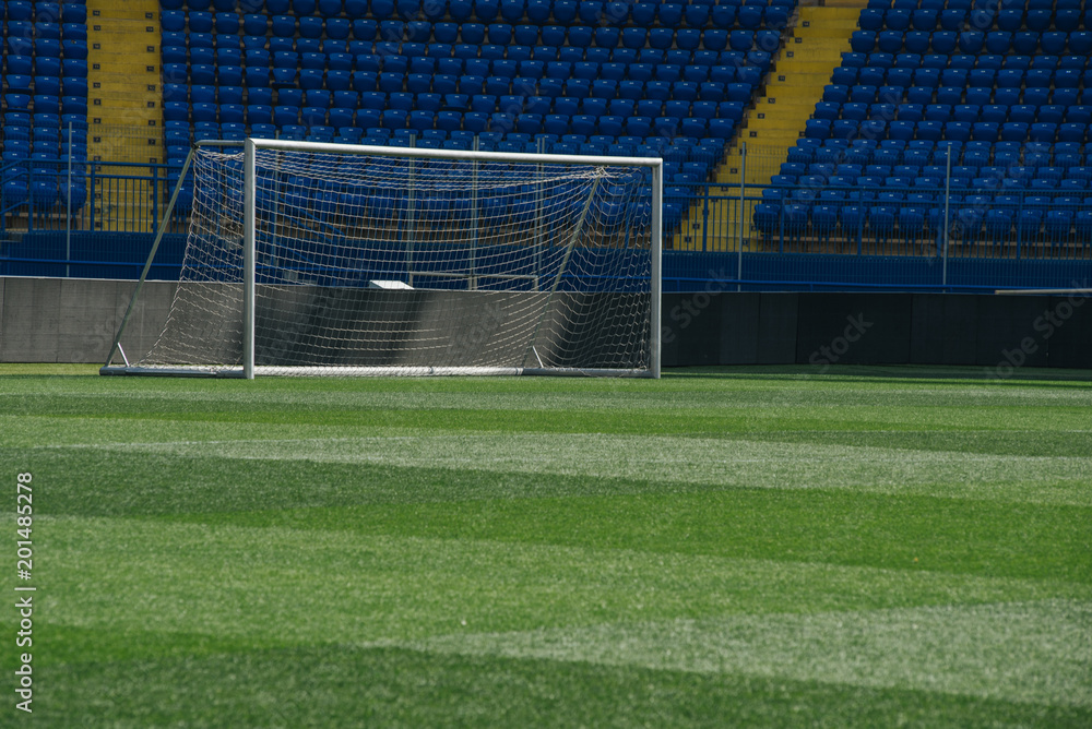 Fototapeta premium On the stadium. Soccer ball on green arena