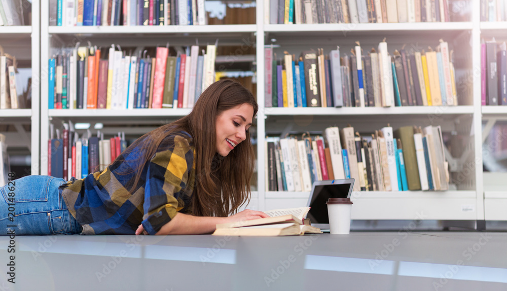 Young female student studying in the library
