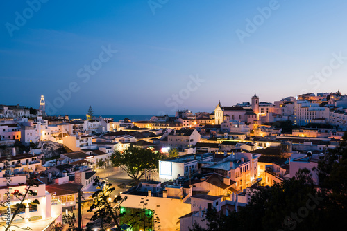 Panoramic, night view of the Old Town of Albufeira City in Algarve, Portugal. Albufeira is a coastal city in the southern Algarve region of Portugal.  photo