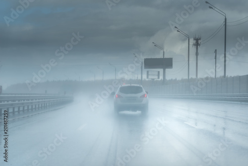 Drive car in rain on asphalt wet road. Clouds without sun photo