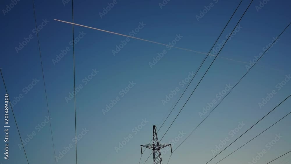 View of Airplane jet layer, aircraft pollution on sky, white trace vapour by evening View of Airplane jet layer, aircraft pollution on sky, white trace vapour by evening