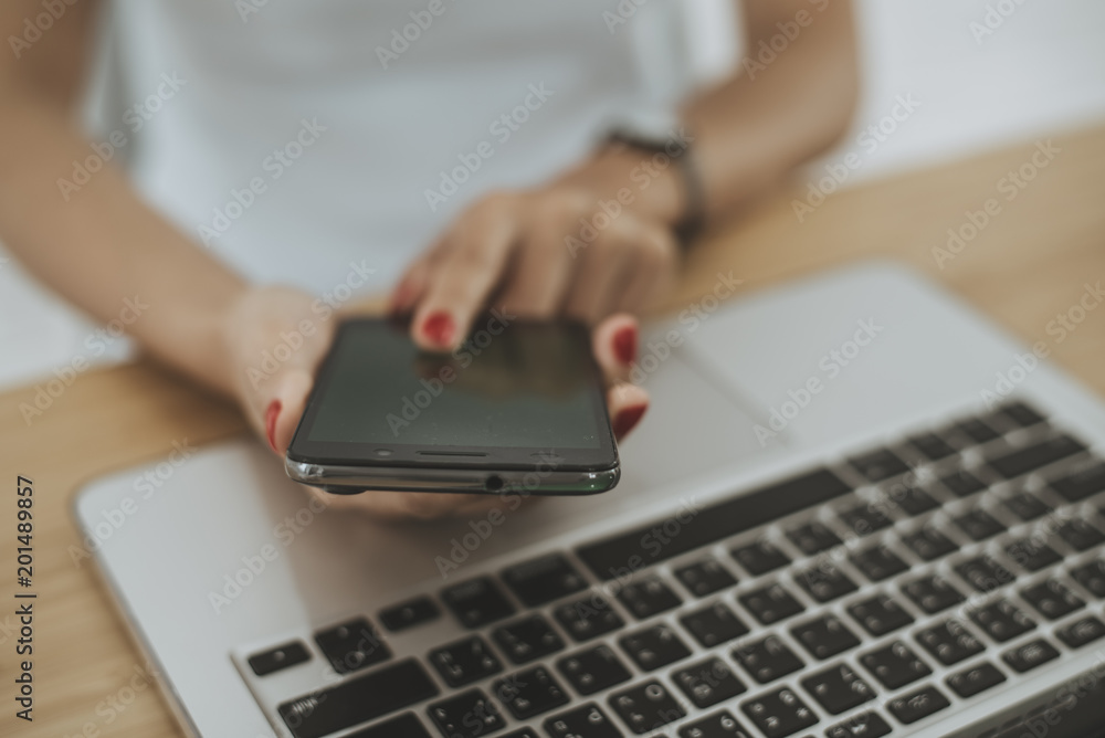 Woman hand with computer laptop on wood table. Woman hand with computer laptop on wood table.